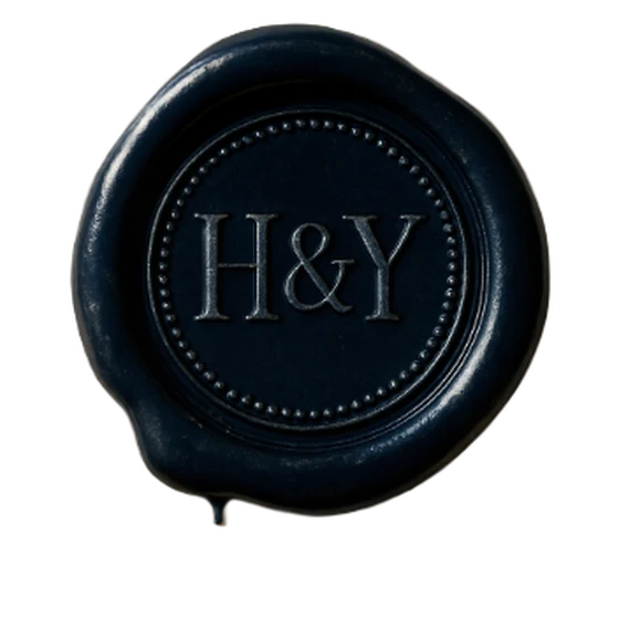 A midnight blue wax seal with the initials H & Y, designed in the Seal Studio